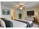 This bedroom boasts a ceiling fan, plant, and a television on a long drawer in a well-lit interior at 1638 River Trc, Auburn, GA 30011