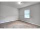 Bright bedroom features neutral tones and natural light from the single window at 1638 River Trc, Auburn, GA 30011