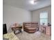 This bonus room features a sewing machine, a desk, a couch and a window in a carpeted space at 1638 River Trc, Auburn, GA 30011