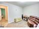 This bonus room has a sewing machine, a chest, a leather couch in a well-lit space at 1638 River Trc, Auburn, GA 30011