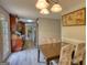 Inviting dining room features a wood table, four chairs and stylish overhead lighting fixture at 1638 River Trc, Auburn, GA 30011