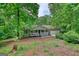 Charming single-story home featuring a quaint front porch and a two-car attached garage nestled among mature trees at 1638 River Trc, Auburn, GA 30011