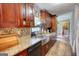 Updated kitchen boasts stone backsplash, farmhouse sink, stainless appliances and ample cabinets at 1638 River Trc, Auburn, GA 30011