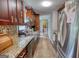 Galley kitchen features granite counters, stainless steel appliances and abundant cabinetry at 1638 River Trc, Auburn, GA 30011