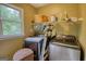 Laundry room with washer, dryer, utility sink, storage and a window view at 1638 River Trc, Auburn, GA 30011