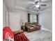 Bright and airy living room featuring sleek flooring, a ceiling fan, and comfortable seating arrangements at 1638 River Trc, Auburn, GA 30011