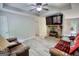Bright living room featuring new flooring, a ceiling fan, and a stone fireplace with a mounted television above at 1638 River Trc, Auburn, GA 30011