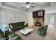 Staged living room featuring modern decor, a stone fireplace with flatscreen television, and neutral-toned flooring and walls at 1638 River Trc, Auburn, GA 30011