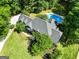 Expansive aerial view of home with swimming pool surrounded by lush greenery at 324 Chimney Sweep Cir, Peachtree City, GA 30269