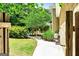 Inviting backyard featuring a walkway to a covered porch and lush greenery at 324 Chimney Sweep Cir, Peachtree City, GA 30269