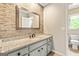 Bathroom featuring granite countertop, gray cabinets, and mosaic backsplash, with toilet and window visible at 324 Chimney Sweep Cir, Peachtree City, GA 30269