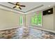 Bright bedroom with tile floors, a ceiling fan, recessed lighting, and large windows offering natural light at 324 Chimney Sweep Cir, Peachtree City, GA 30269