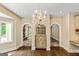 Dining room featuring a granite wet bar, chandelier, hardwood floors, and arched doorways leading to other rooms at 324 Chimney Sweep Cir, Peachtree City, GA 30269