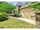 Exterior backyard view featuring a deck, lush lawn, and stucco siding at 324 Chimney Sweep Cir, Peachtree City, GA 30269