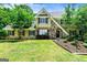 Charming two-story home with stone and stucco facade, complemented by manicured landscaping at 324 Chimney Sweep Cir, Peachtree City, GA 30269