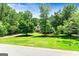 Spacious home exterior with lush front yard and mature trees, offering privacy at 324 Chimney Sweep Cir, Peachtree City, GA 30269
