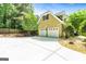 Three car garage with an extra large driveway for additional parking at 324 Chimney Sweep Cir, Peachtree City, GA 30269