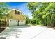 Detached three car garage and driveway in a wooded setting at 324 Chimney Sweep Cir, Peachtree City, GA 30269