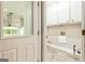 Laundry room near garage entrance, including tile floors, and cabinetry at 324 Chimney Sweep Cir, Peachtree City, GA 30269