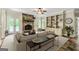 Cozy living room with a stone fireplace, built-in shelving, and French doors leading to the outdoor area at 324 Chimney Sweep Cir, Peachtree City, GA 30269