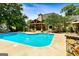 Stunning backyard pool and covered patio, ideal for outdoor entertaining and relaxation at 324 Chimney Sweep Cir, Peachtree City, GA 30269