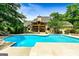 Beautiful swimming pool and covered patio surrounded by landscaping, creating a private oasis at 324 Chimney Sweep Cir, Peachtree City, GA 30269