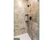 Modern shower with marble-look tile and black fixtures at 324 Chimney Sweep Cir, Peachtree City, GA 30269