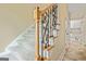 Carpeted staircase features decorative wrought iron spindles, natural wood and neutral walls at 324 Chimney Sweep Cir, Peachtree City, GA 30269