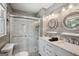 Modern bathroom showcasing marble-like tiling, glass-enclosed shower, and a double sink vanity at 120 Bowfin Bay, Peachtree City, GA 30269