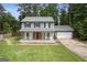 Charming gray two-story home featuring a welcoming front porch, red door, and lush green lawn at 120 Bowfin Bay, Peachtree City, GA 30269