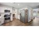 Spacious kitchen with stainless steel appliances, white cabinets, and a tile backsplash at 120 Bowfin Bay, Peachtree City, GA 30269