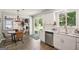 Bright kitchen with white cabinetry, stainless steel appliances, and a view to the dining area and backyard at 120 Bowfin Bay, Peachtree City, GA 30269