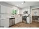 Bright kitchen featuring white cabinetry, stainless steel appliances, and a window at 120 Bowfin Bay, Peachtree City, GA 30269