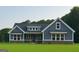 Charming blue home featuring stone accents, a covered porch, and large windows showcasing curb appeal at 1273 Jersey Social Circle Rd, Covington, GA 30014