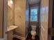 Neutral powder room with pedestal sink and natural light from window at 1946 Jeffery Nw Rd, Atlanta, GA 30318