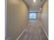 Well-lit hallway featuring neutral walls, plush carpet, and access to multiple rooms at 1946 Jeffery Nw Rd, Atlanta, GA 30318