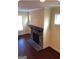 Living room area with hardwood floors, brick fireplace, and large windows for natural light at 1946 Jeffery Nw Rd, Atlanta, GA 30318
