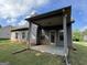 View of the home's back patio and backyard featuring green lawn and covered ceiling at 6703 Biscayne Blvd, Rex, GA 30273