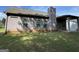 Exterior view of the house showcasing the backyard with green lawn and covered patio at 6703 Biscayne Blvd, Rex, GA 30273