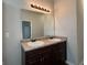 Bathroom with double sinks, and overhead vanity lights at 6703 Biscayne Blvd, Rex, GA 30273