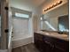Bright bathroom with a double sink vanity and a shower with bathtub at 6703 Biscayne Blvd, Rex, GA 30273