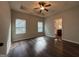 Bedroom with wood floors, a ceiling fan, and two bright windows at 6703 Biscayne Blvd, Rex, GA 30273