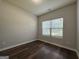 Bedroom with wood-look flooring, window, and natural light at 6703 Biscayne Blvd, Rex, GA 30273