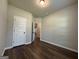 This is a bedroom with wood-look flooring and a large door at 6703 Biscayne Blvd, Rex, GA 30273