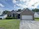 Charming brick home with a manicured lawn, a two-car garage and mature landscaping at 6703 Biscayne Blvd, Rex, GA 30273