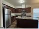Lovely kitchen featuring a spacious island, stainless steel appliances, granite countertops, and ample cabinet space at 6703 Biscayne Blvd, Rex, GA 30273