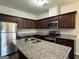 Stylish kitchen featuring granite countertops, stainless steel appliances, and a spacious island for food preparation at 6703 Biscayne Blvd, Rex, GA 30273