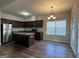 Modern kitchen with stainless steel appliances, granite countertops, rich cabinetry, and a functional center island at 6703 Biscayne Blvd, Rex, GA 30273