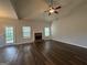 Spacious living area featuring a brick fireplace, vaulted ceiling, and hardwood floors with door to outdoor area at 6703 Biscayne Blvd, Rex, GA 30273