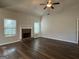 Bright living room featuring a traditional brick fireplace and windows at 6703 Biscayne Blvd, Rex, GA 30273